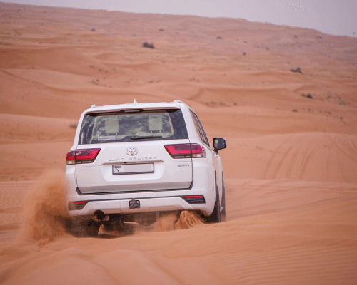 toyota land cruiser is doing dune bashing in dubai desert