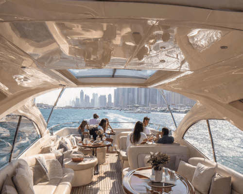 Guests relaxing in the air-conditioned indoor lounge of the yacht, with comfortable sofas and large windows overlooking the sea. Guests relaxing in the air-conditioned indoor lounge of the yacht, with comfortable sofas and large windows overlooking the sea.